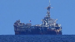 Philippine officials say Chinese forces seized 2 navy boats in disputed shoal, injuring sailors